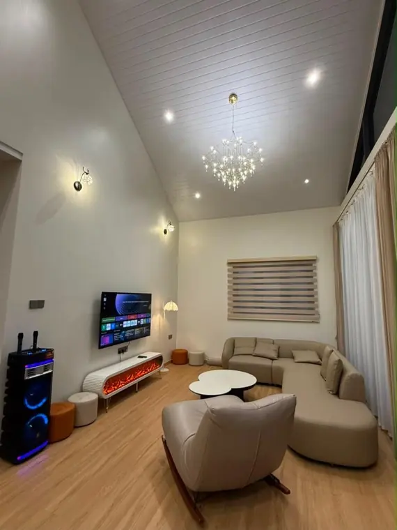Earth's double-height lounge under a crystal chandelier