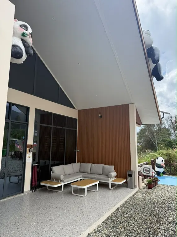 Earth's covered patio lounge, watched over by panda statues on the roofline