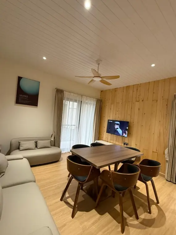 Neptune's living room with sofa, dining table and smart TV