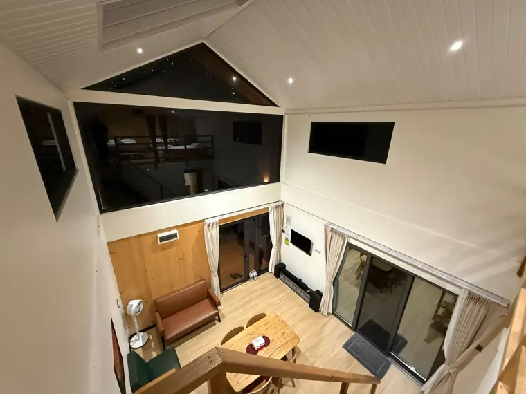 Double-height living room in a Starlight residence, mezzanine above