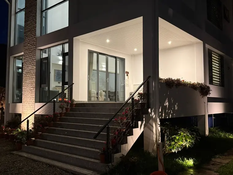 Saturn's lit entrance steps and garden at night