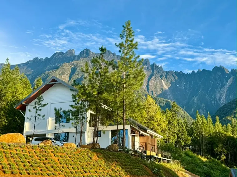 Saturn Villa on its terraced hillside, Mount Kinabalu's granite peaks rising behind the pines